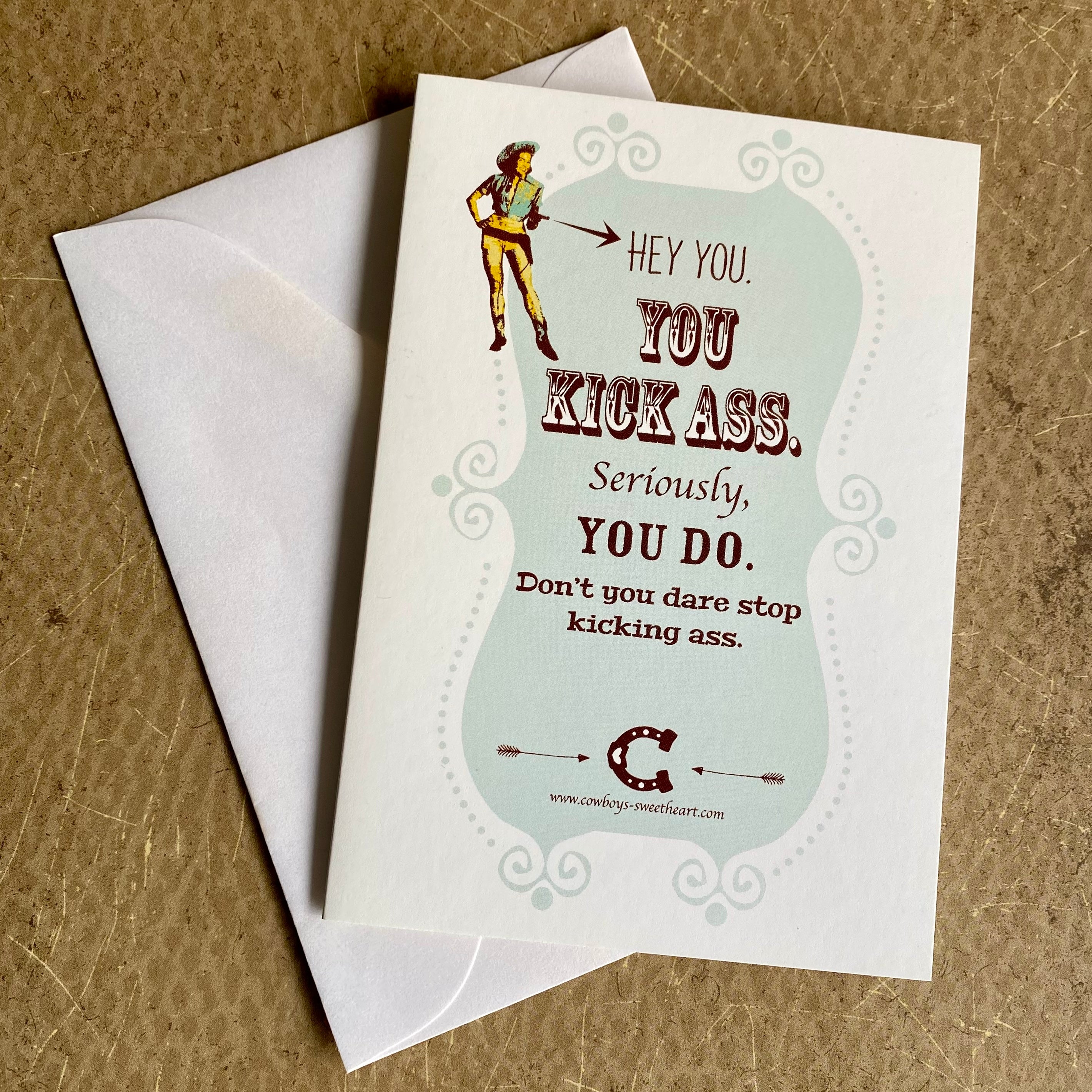 Motivational card with text and illustration on a brown surface
