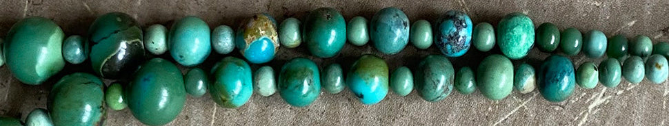 Green beaded necklace on a textured surface