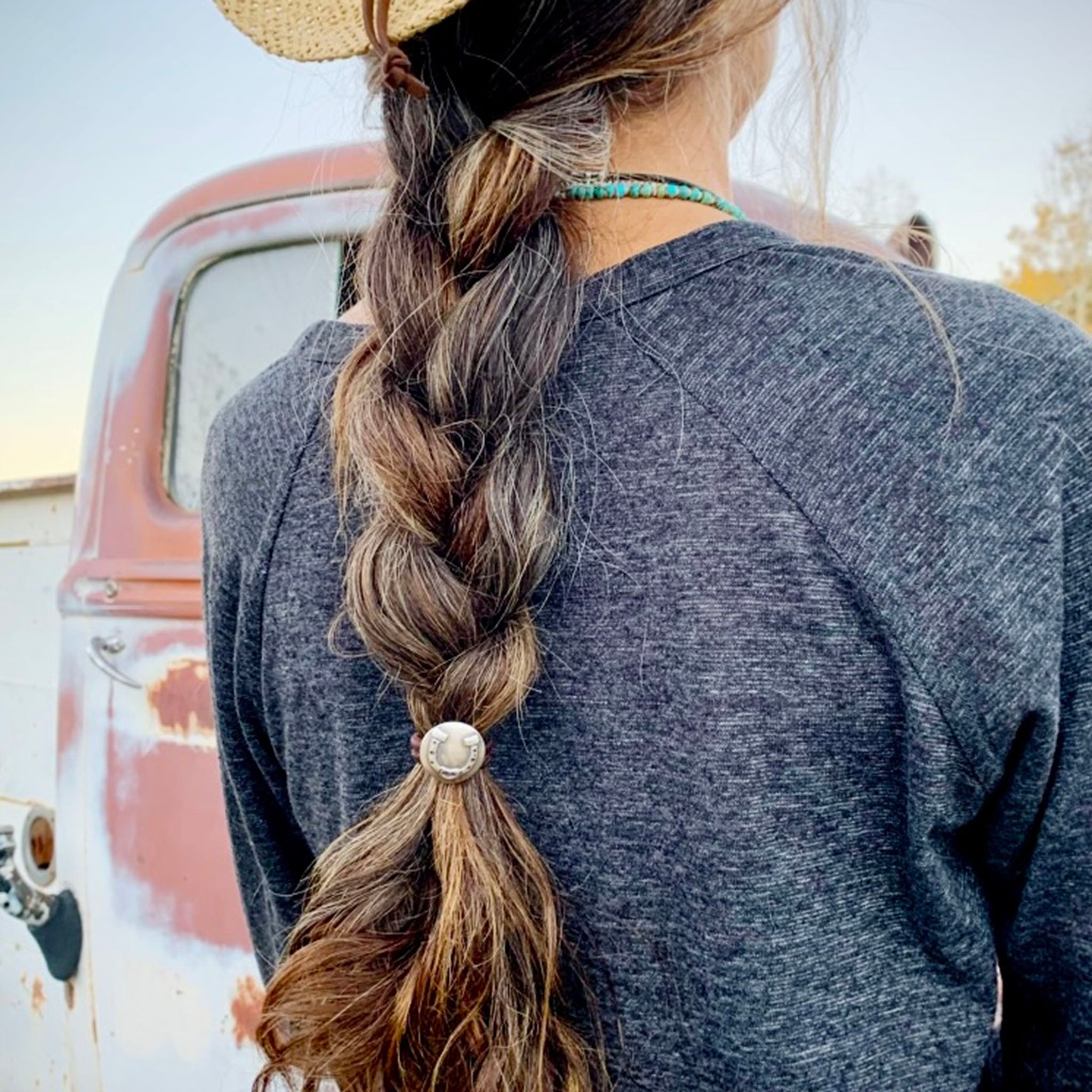 Amy with braided hair wearing Hair Tie with Horshoe shape