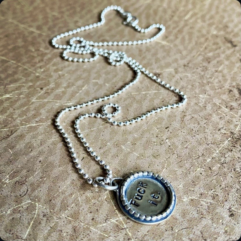 Necklace with a pendant on a textured surface